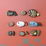 Rocks painted as fish to showcase the use of acrylic paint on rocks - Stationery Island 