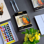 An A5 Pencilmarch artist watercolour paper pad with 300 gsm paper and 30 pages next to a paint palette and some flowers - Stationery Island