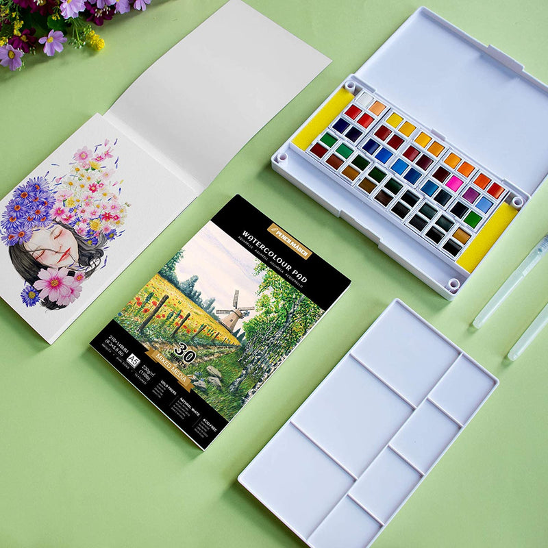 An A5 Pencilmarch watercolour paper pad with 230 gsm paper and 30 pages next to a paint palette and a painting of a girl surrounded by flowers - Stationery Island