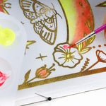 A scarf being painted using the paints from the TBC mystical moons paint your own scarf - Stationery Island
