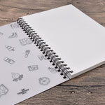 An opened A4 spiral bound sketchbook, which is  included in the pack of 2 A4 spiral bound sketchbooks - Stationery Island