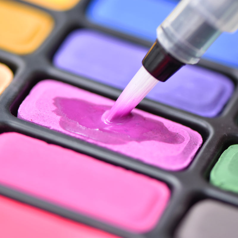 An aqua brush used on a paint colour from the creative collection watercolour paint set that has 12 colours - Stationery Island