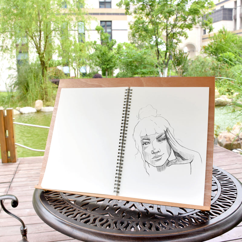 A girl being sketched inside one of the sketchbooks that is included in the pack of 2 A3 spiral bound sketchbooks - Stationery Island