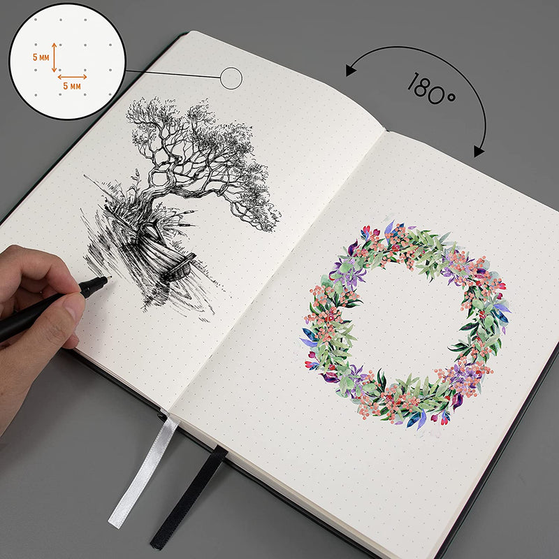 A tree being drawn inside the black A5 dotted notebook with accessories, bullet journal - Stationery Island