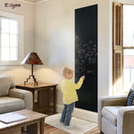 A boy drawing on the chalkboard sticker that's been stuck to the wall - Stationery Island