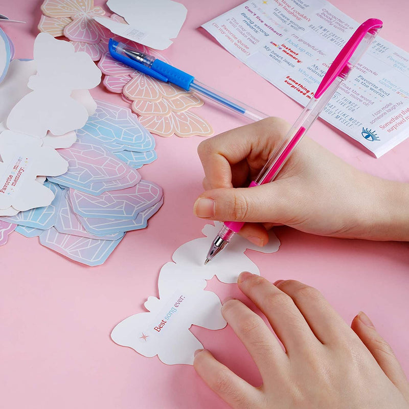 A person writing with a pen on a card that are both included with the TBC create your own wish jar - Stationery Island