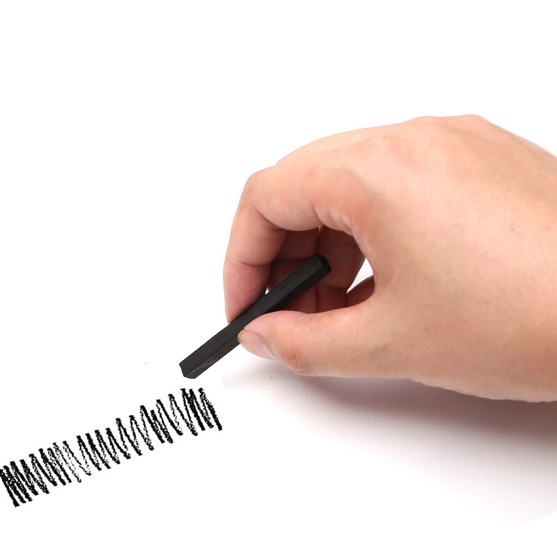A person scribbling using a charcoal stick - Stationery Island 