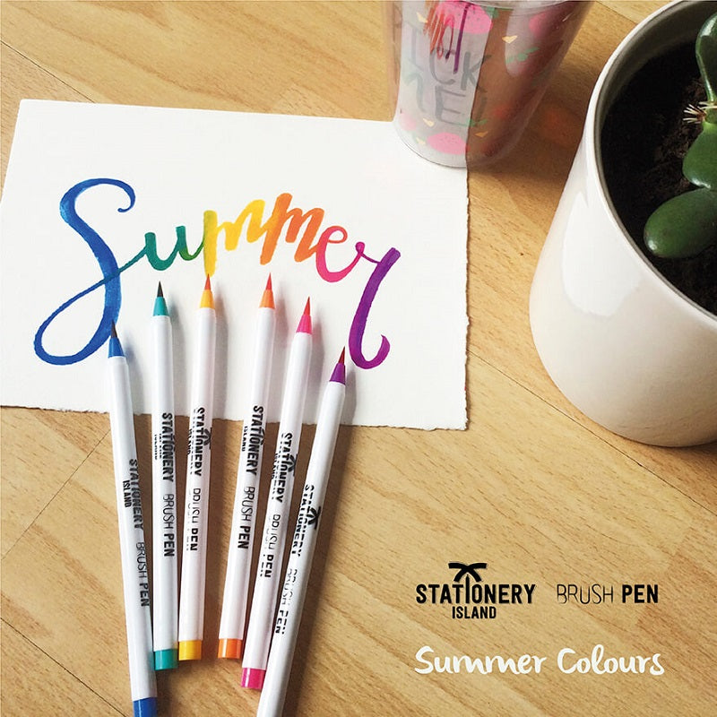 The word summer drawn on a paper by using the summer colours brush pens - Stationery Island 