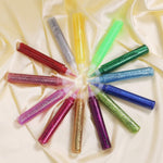Different colours of TBC glitter glue pens laid down in a circle - Stationery Island